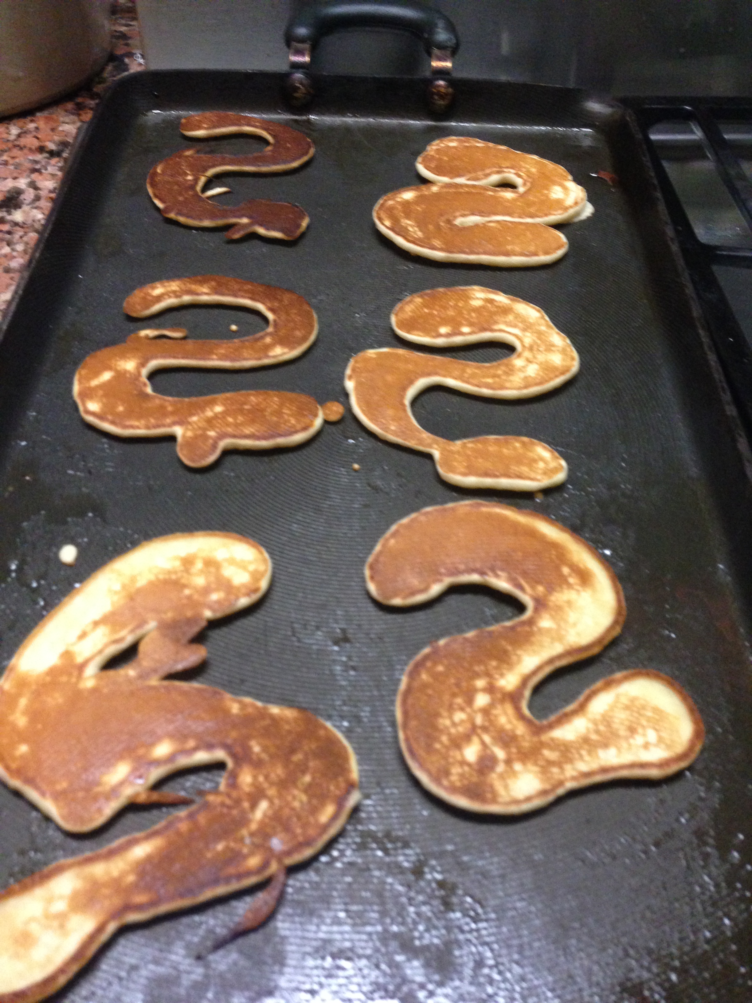 Snake pancakes without green dye on grill pan