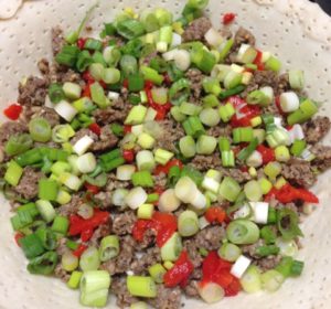 Pie shell with sausage, green onions and pimentos