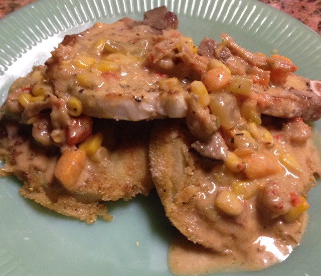 Seared Bone-In Pork Chop, Eggplant and covered in Spicy Corn-N-Crawfish Sauce