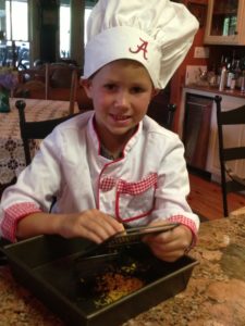 Wee Chef with Alabama Chef's Hat grating cheese