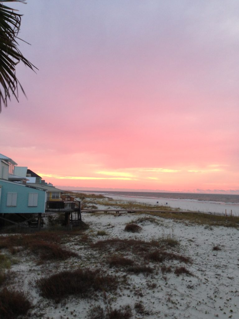 Beach view in Gulf Shores Alabama with colorful sunset