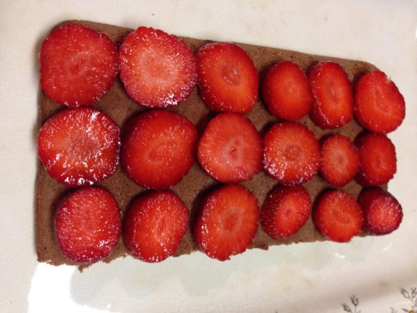 Layer strawberries on cake