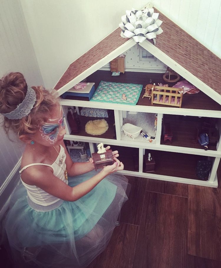 Princess in front of her Mom's Dollhouse