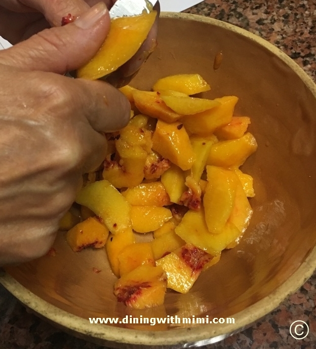 Peeling fresh peaches for Rustic Peach Tart www.diningwithmimi.com