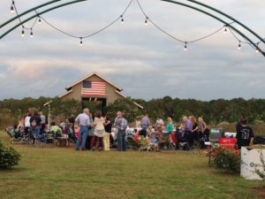  Weeks Bay Plantation barn with American Flag, lots of people waiting for concert www.diningwithmimi.com
