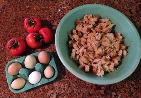 Rust colored granite with persimmons, eggs and large turquoise bowl www.diningwithmimi.com