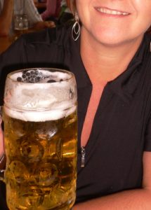 Frosty large beer held by happy person Fairhope's White Linen Night Event www.diningwithmimi.com