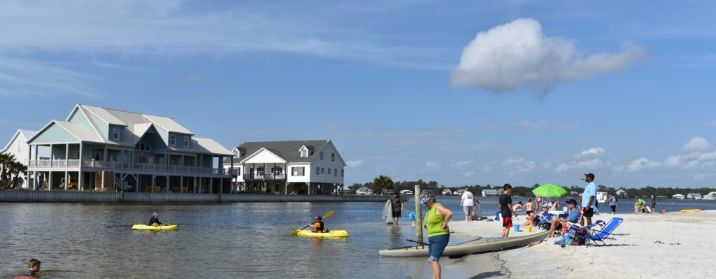 Beach view with sunbathers, kayaks, and Mimi's Celebrate Summer Menu Before It Disappears www.diningwithmimi.com