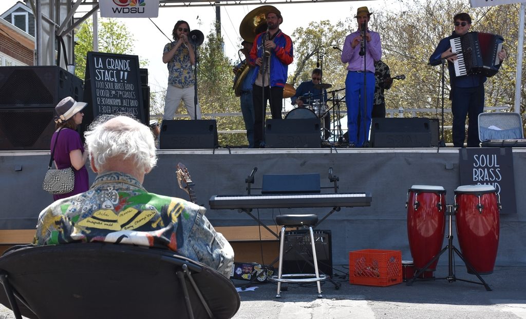 5 piece Band playing on stage in front of seated fan Need a quickie- Drop into New Orleans for 48 hours www.diningwithmimi.com