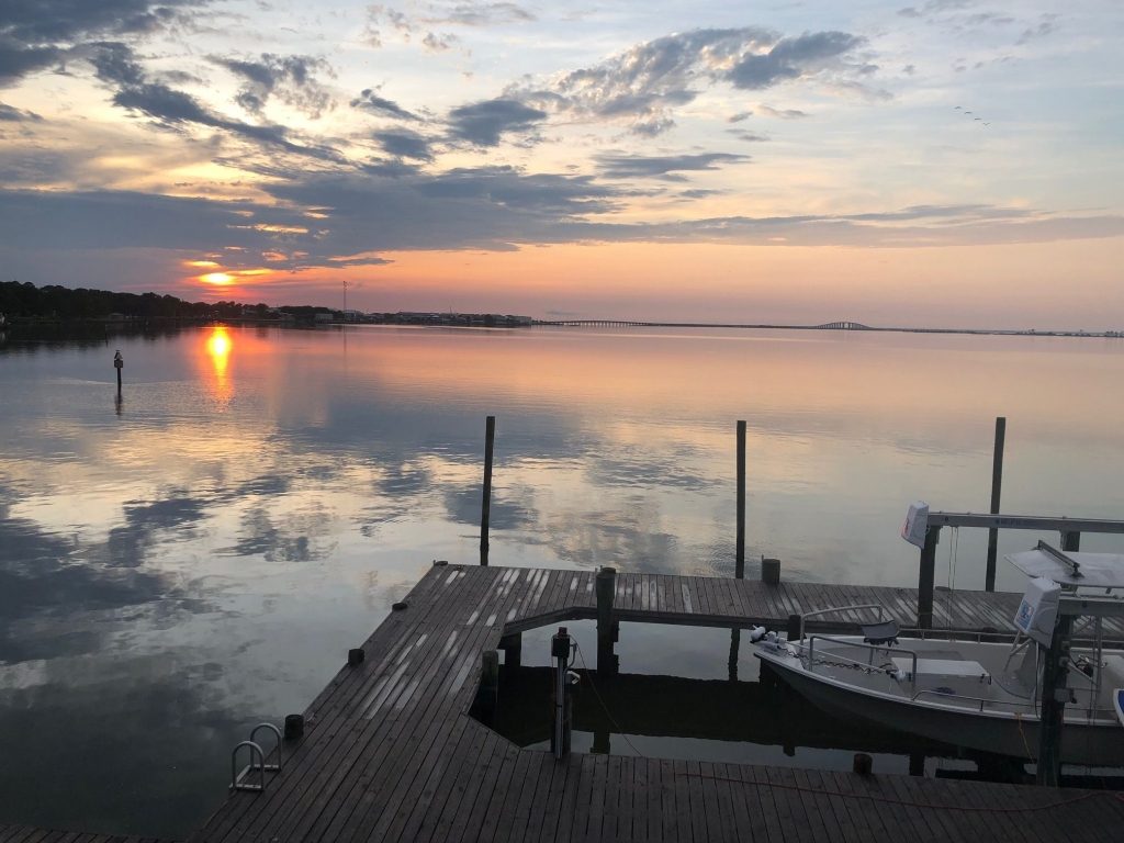 Orange Sunset on still water with sky reflections of clouds and sun setting for My Daupin Island Restorative Paddle www.diningwithmimi.com