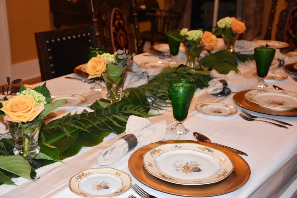 Dining Table with Fire King forest green glasses and antique dishes and greenery used as runner www.diningwithmimi.com