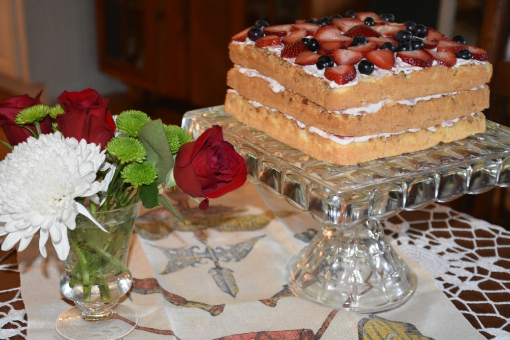 Triple layer light cake with creamy strawberry filling. Recipe at www.diningwithmimi.com