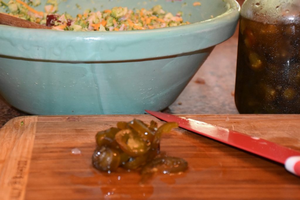 Turquoise Roseville Pottery filled with Broccoli Salad and candied jalapeno www.diningwithmimi.com