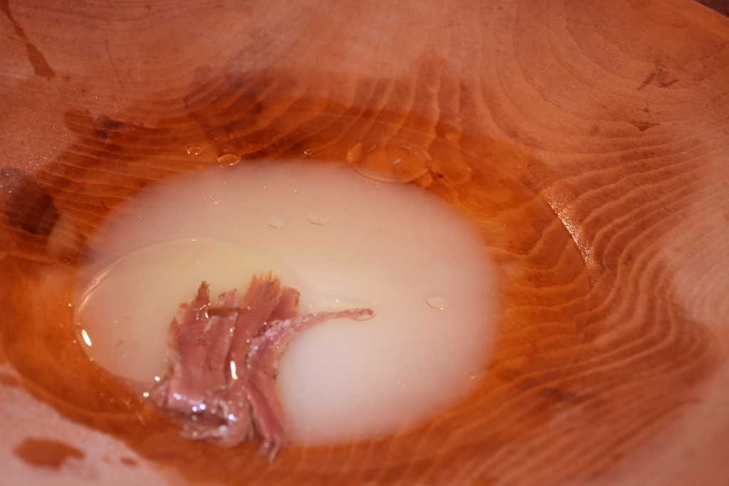 Old wooden bowl perfect for premade side salad. Sugar, Vinegar and anchovy starts the dressing.